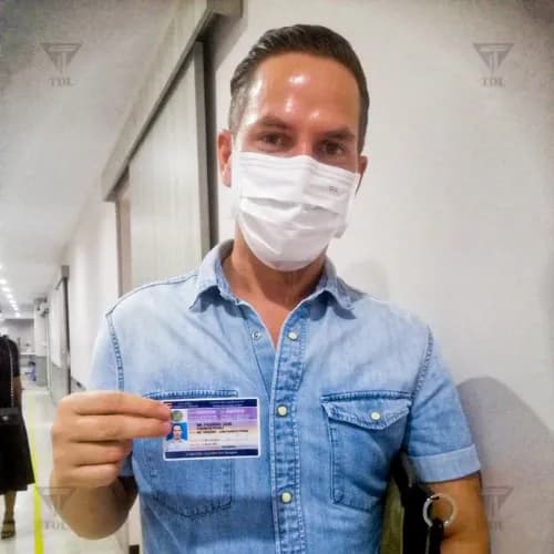 Client holding new Thai driving license at DLT office