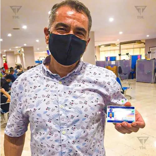 Client proudly showing new Thai driving license